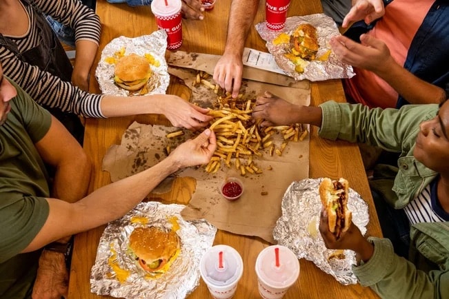 Group sharing burgers and fries