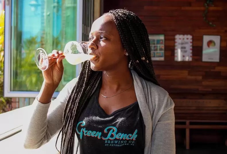 Woman enjoying a craft beer at Green Bench Brewing Co.