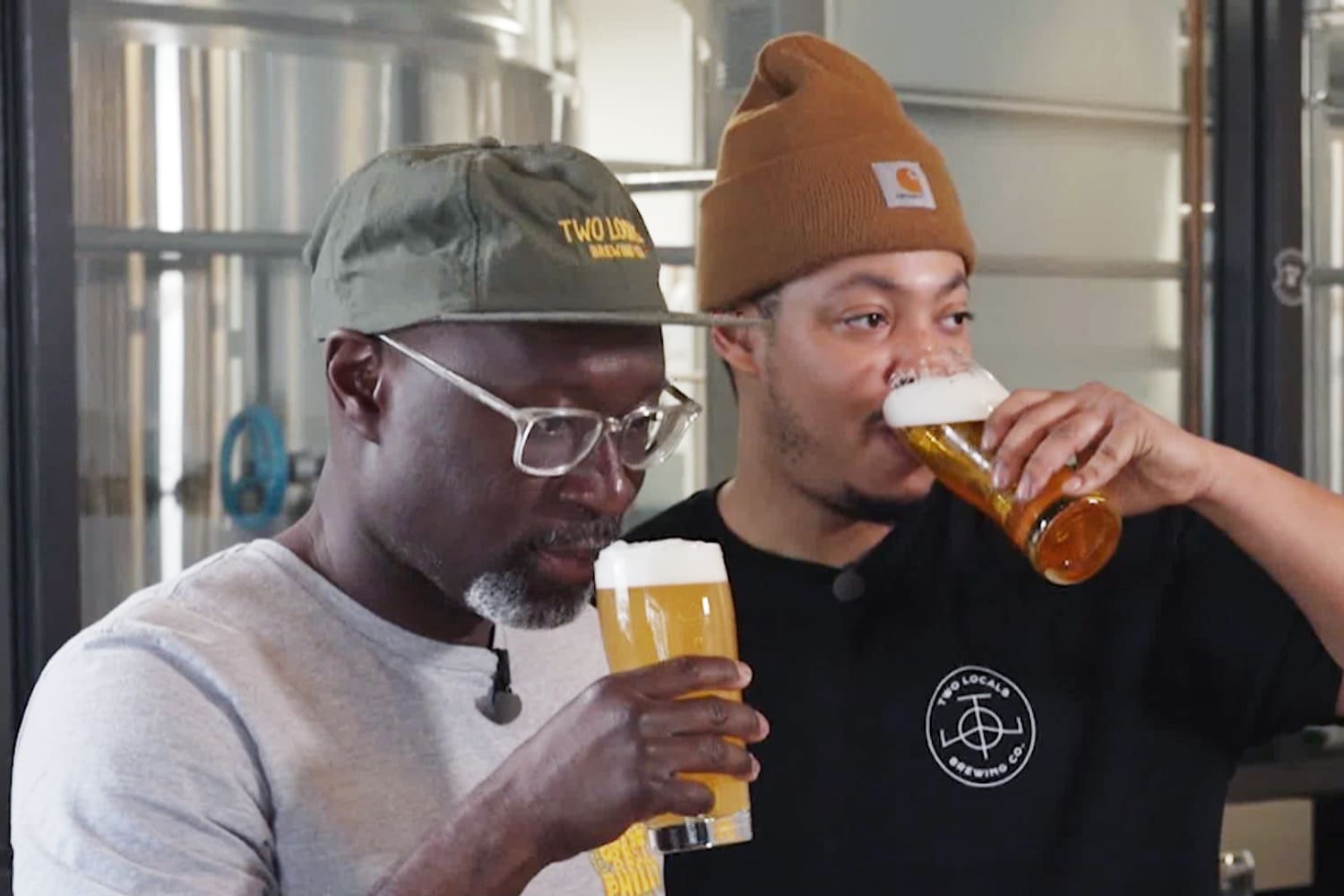 Two Locals Brewing Co. founders drinking craft beer in their taproom