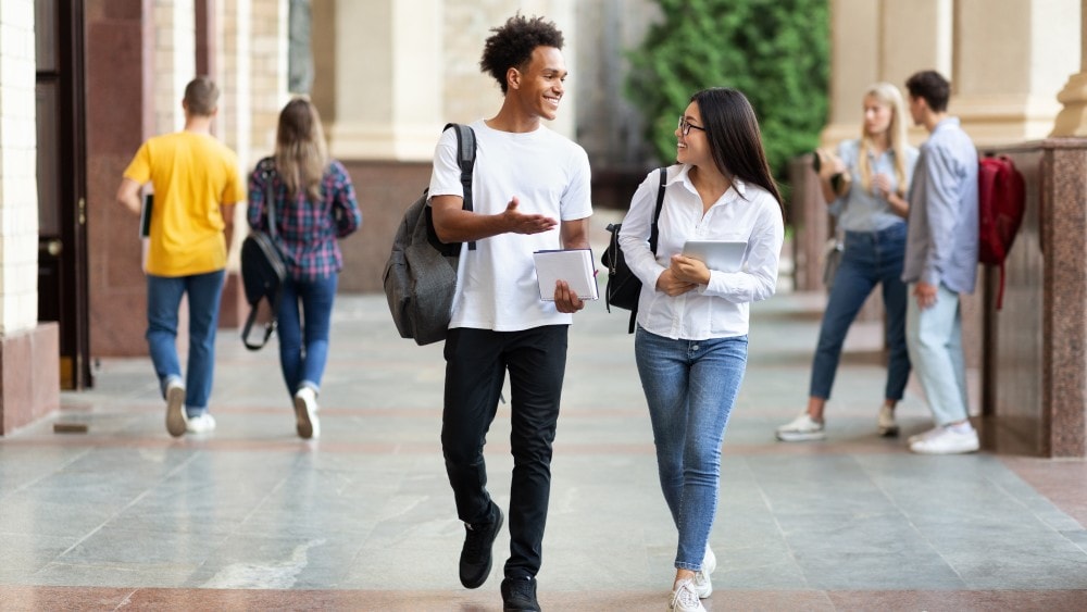 College students walking and talking on campus