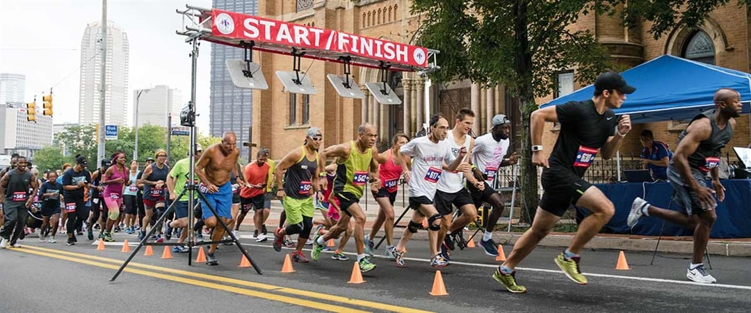 Participants crossing the Start/Finish line at the Historic Hill 5K in Pittsburgh's Hill District