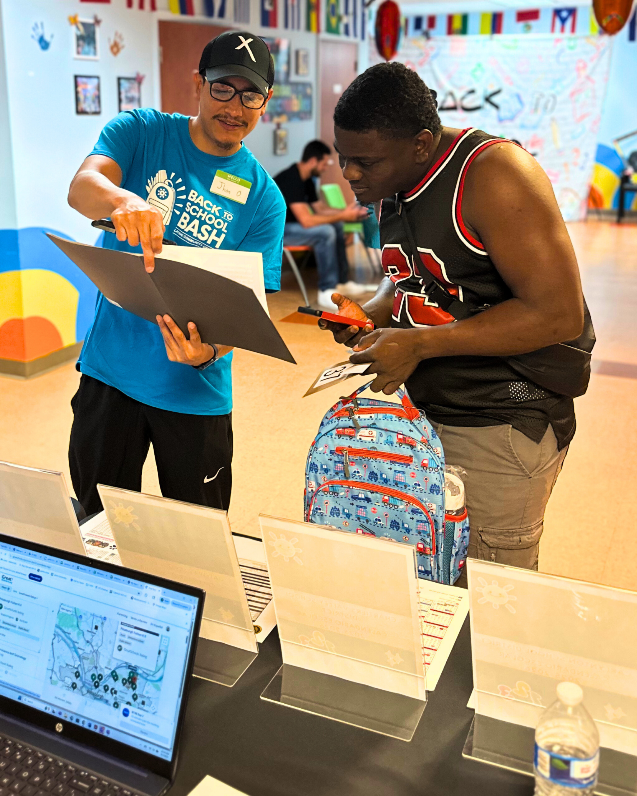 Volunteer helping a family at a back-to-school bash event