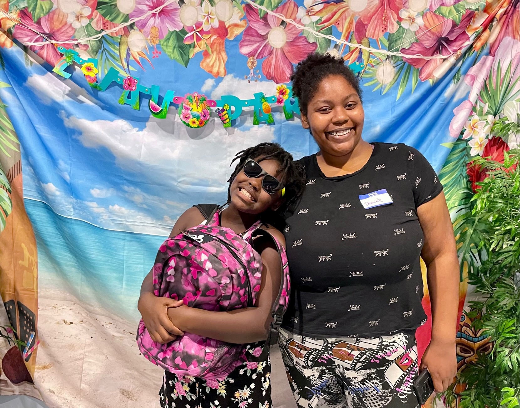 A child and parent smiling at a back-to-school bash event