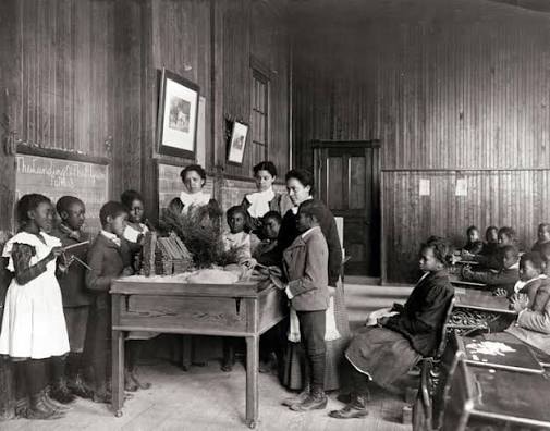 Historic photograph of Black children in an early American classroom, circa early 1900s