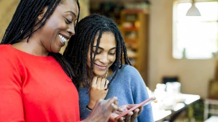 Parent and teen looking at phone — Pittsburgh youth curfew awareness