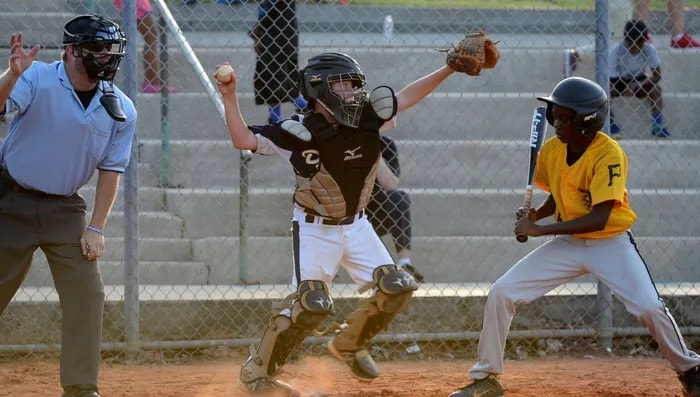 Youth baseball catcher, batter, and umpire at home plate