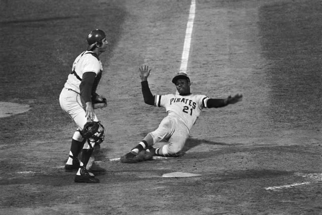 Roberto Clemente No. 21 slides home in a Pittsburgh Pirates game