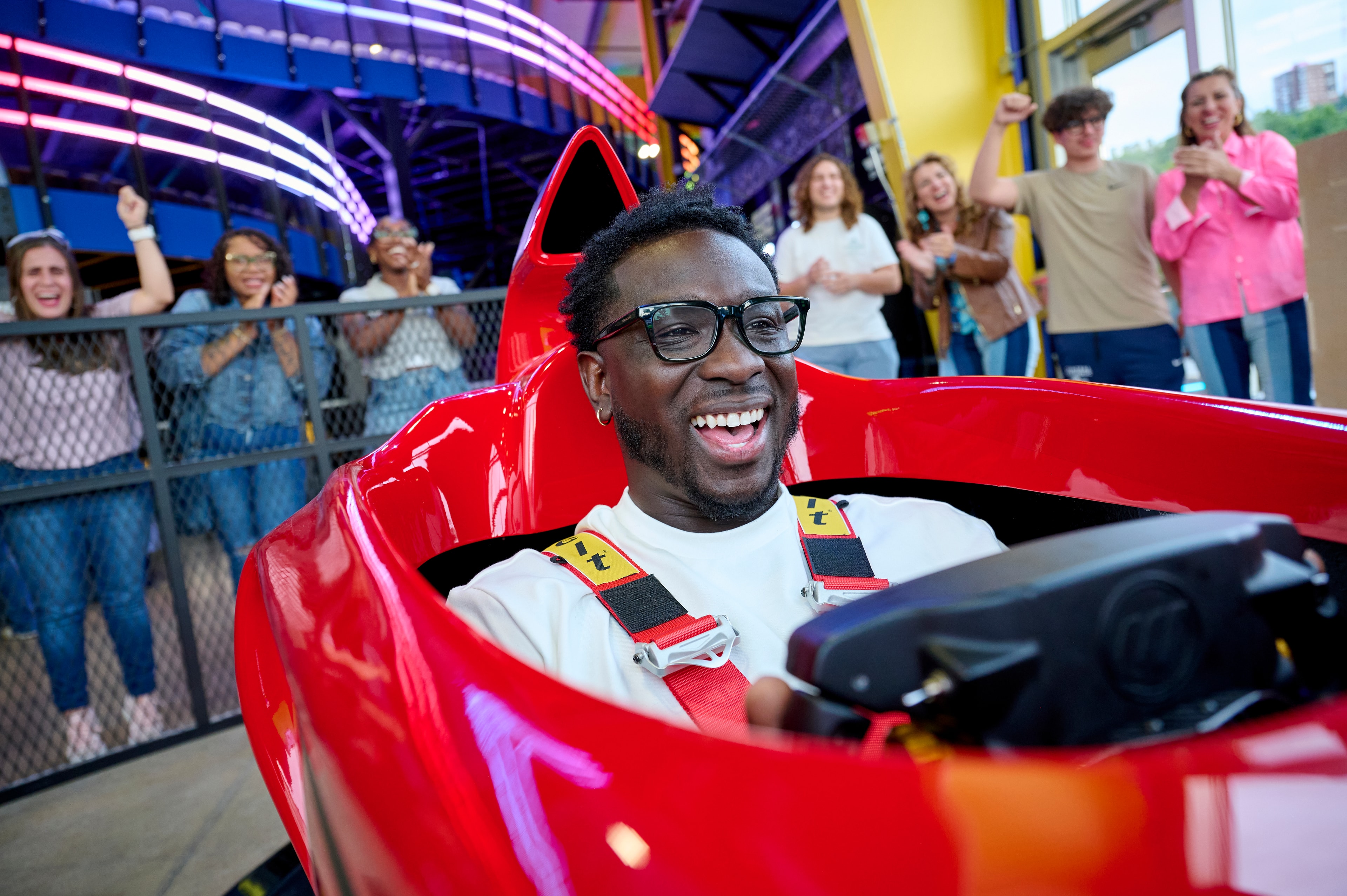 A visitor laughing with excitement inside the WAVE Italy F1 Motion Simulator at Science of Speed
