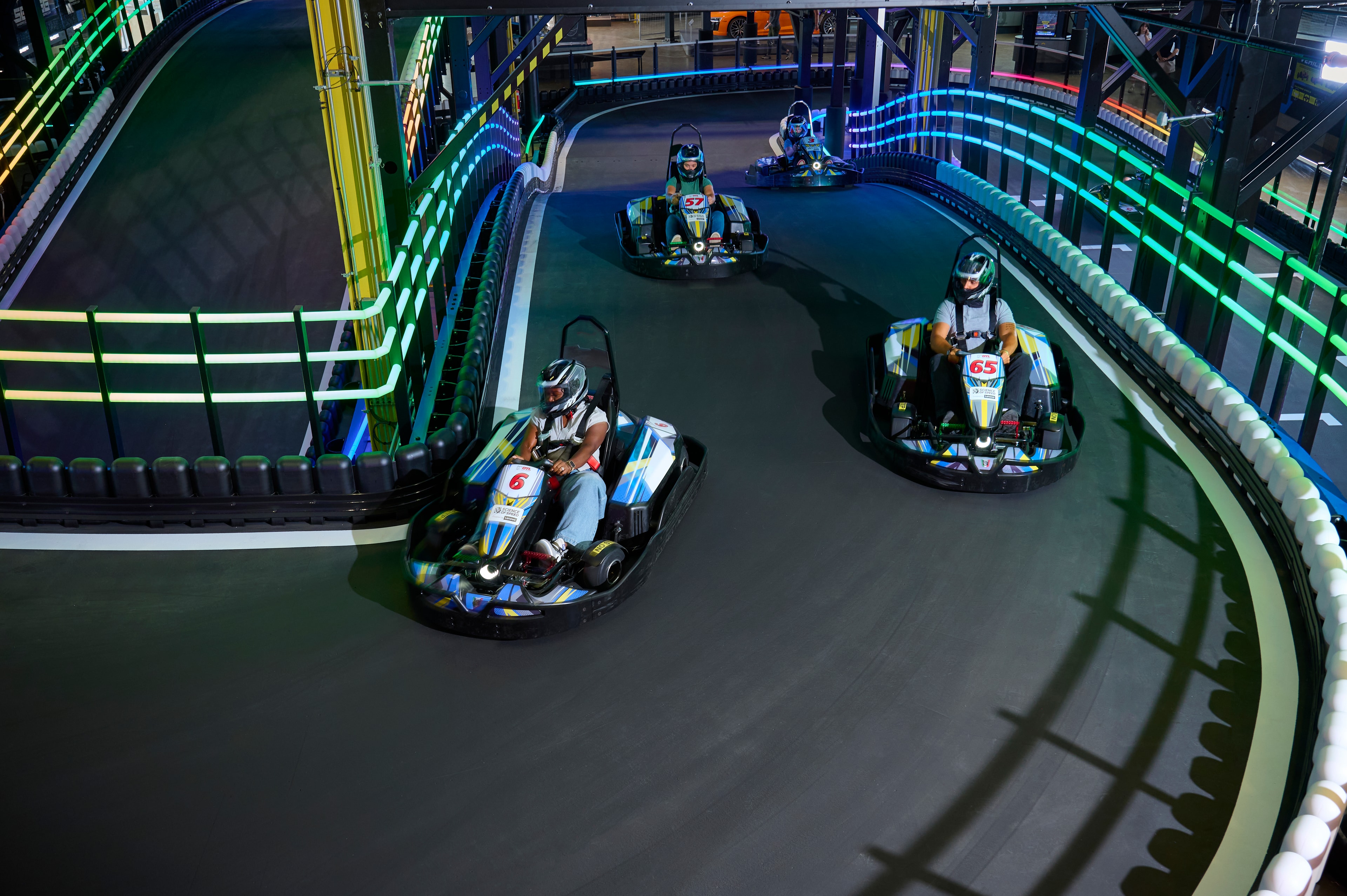 Electric karts racing on the multi-level indoor track at Science of Speed, Kamin Science Center