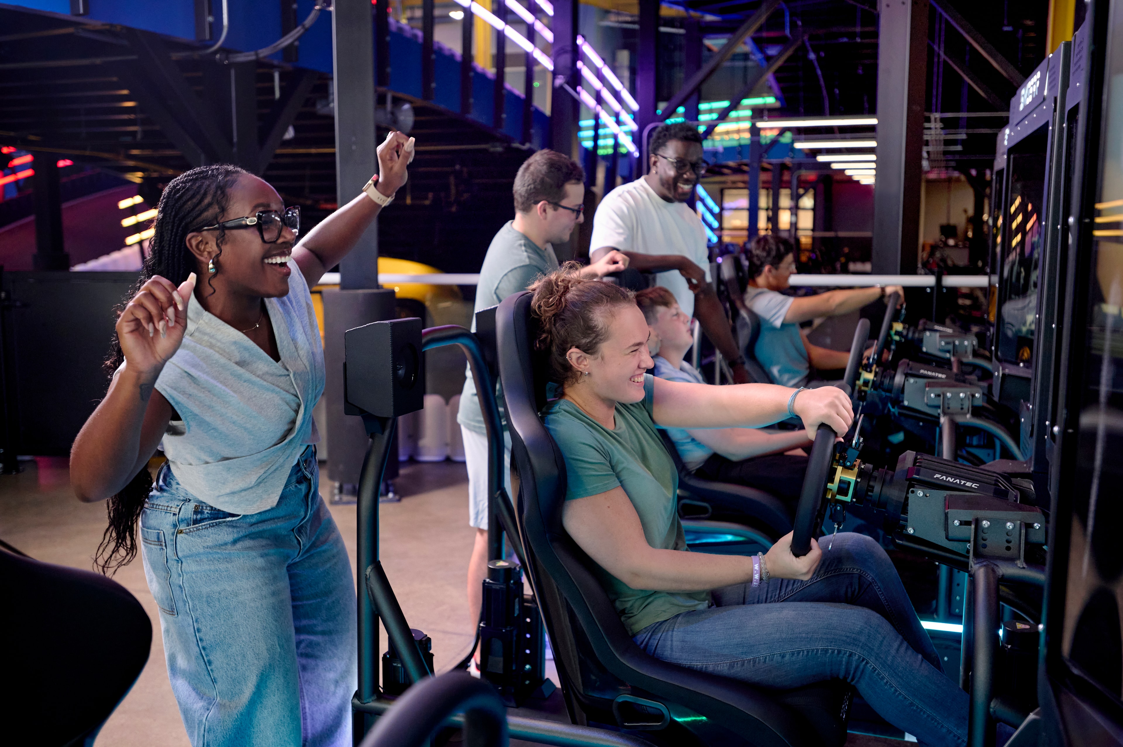 Visitors enjoying the SimGear racing simulators at Science of Speed