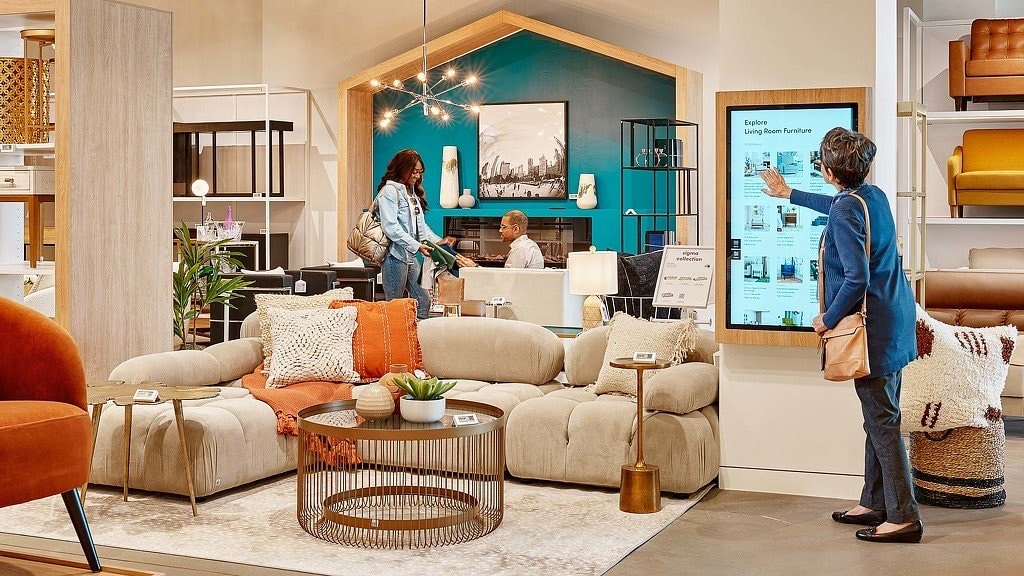 Wayfair showroom interior with furniture displays, design studio, and digital kiosks