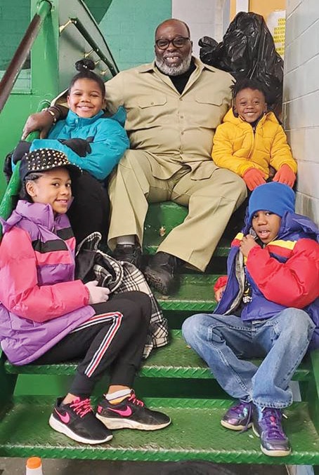 T. Rashad Byrdsong with CEA youth on stairs
